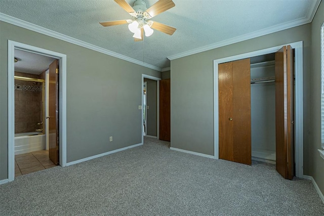 unfurnished bedroom featuring baseboards, a textured ceiling, ornamental molding, and carpet flooring