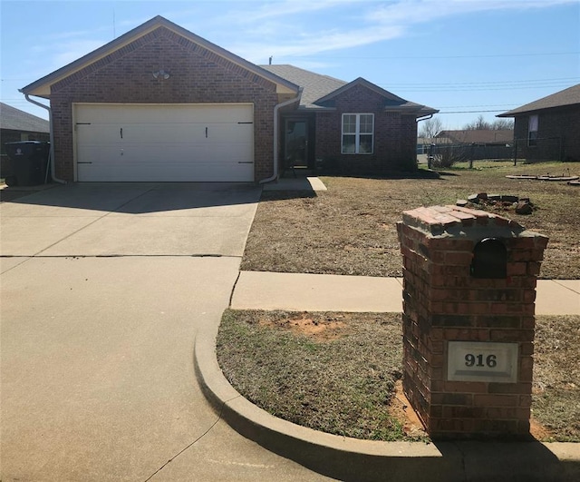 ranch-style home featuring a garage, brick siding, and driveway