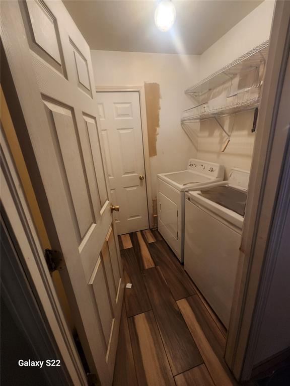 laundry room featuring washer and dryer, laundry area, and dark wood-type flooring