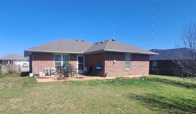 back of house with a patio area, a yard, brick siding, and fence