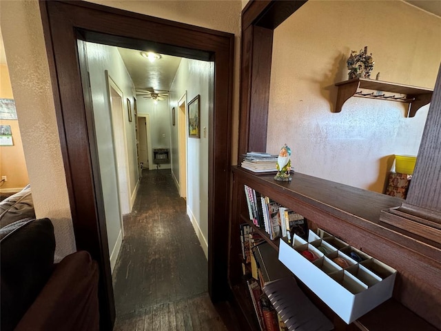 hallway with baseboards and wood finished floors