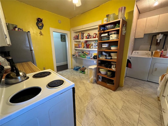 kitchen featuring white electric range oven, open shelves, light countertops, separate washer and dryer, and freestanding refrigerator