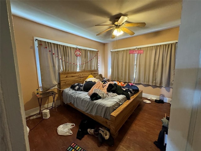 bedroom with baseboards, a ceiling fan, and wood finished floors