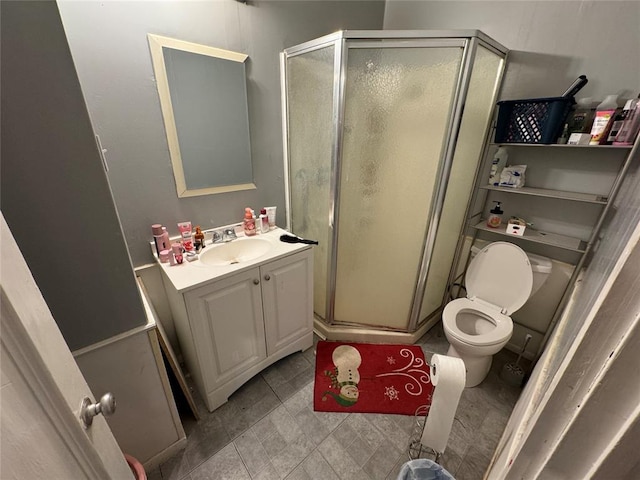 full bathroom featuring a stall shower, toilet, tile patterned floors, and vanity
