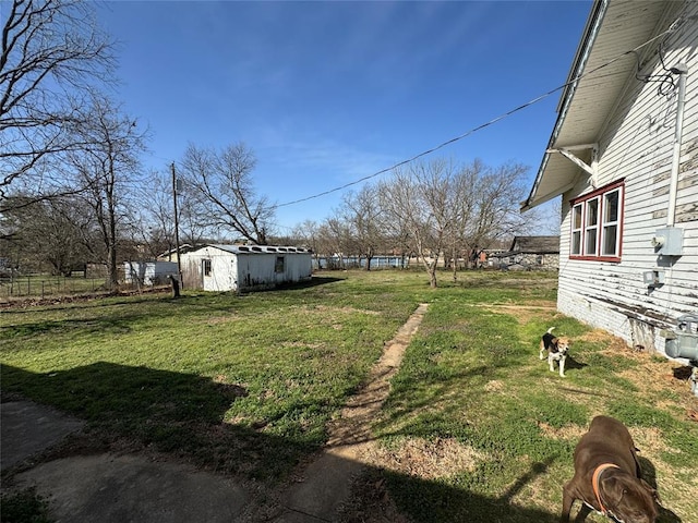 view of yard with an outbuilding and a shed