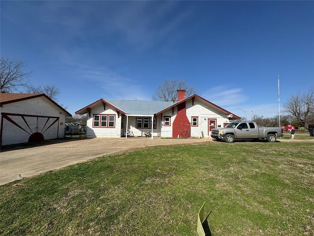 single story home with a chimney, metal roof, and a front yard