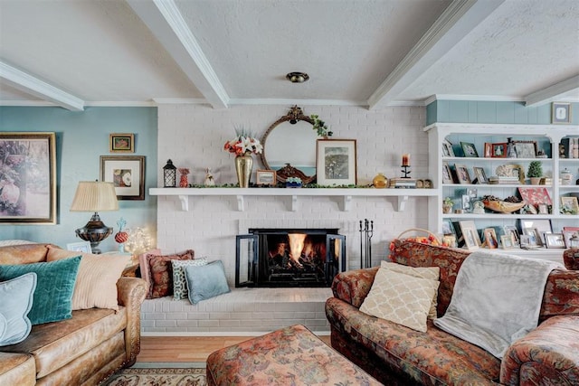 living area featuring beam ceiling, crown molding, wood finished floors, and a textured ceiling