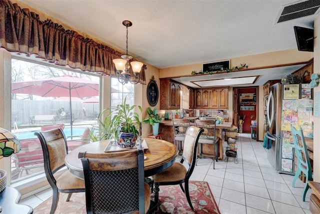 dining room featuring light tile patterned floors and visible vents