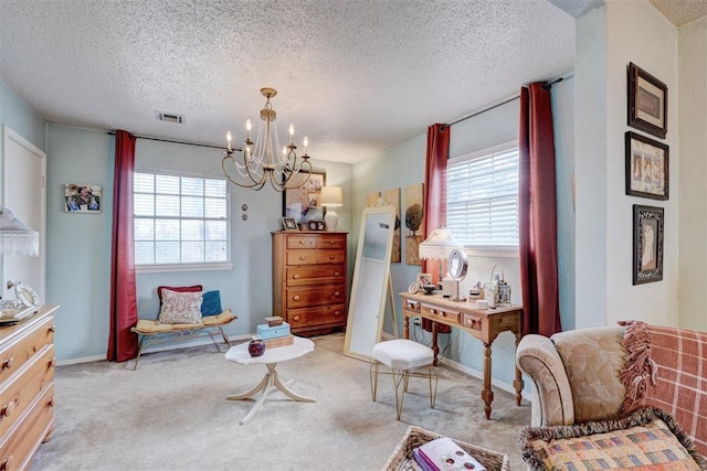 living area featuring a wealth of natural light, visible vents, carpet floors, and a notable chandelier