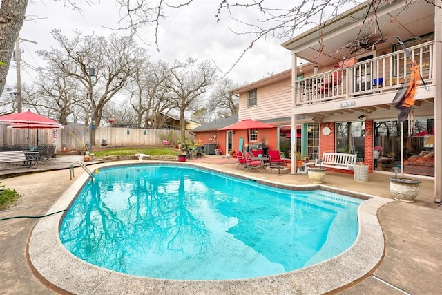 view of swimming pool with a patio, a fenced in pool, a diving board, and a fenced backyard