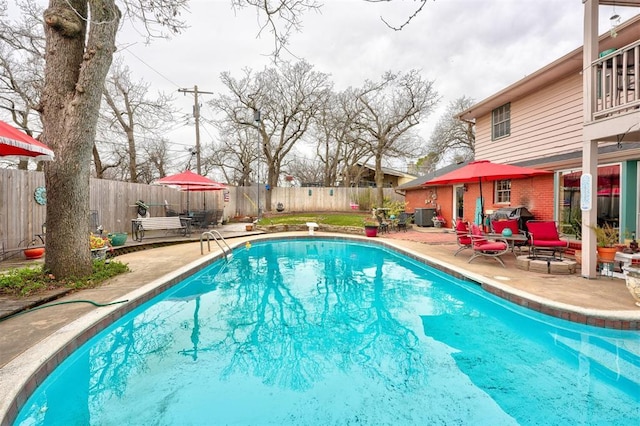 view of pool with area for grilling, a patio area, a fenced in pool, and a fenced backyard