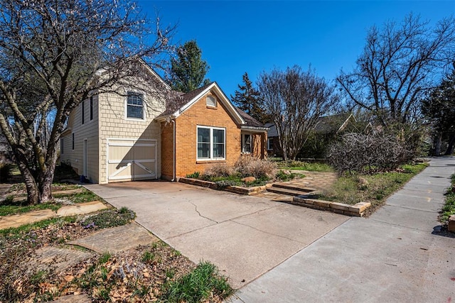 view of front of house featuring brick siding and driveway