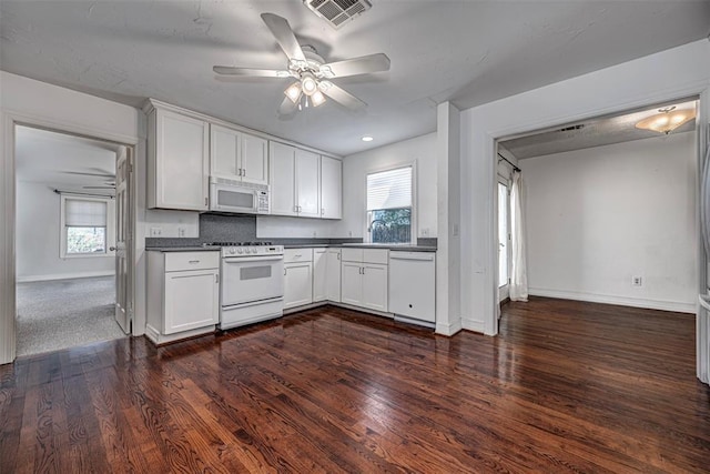 kitchen with visible vents, dark countertops, white appliances, ceiling fan, and dark wood-style flooring