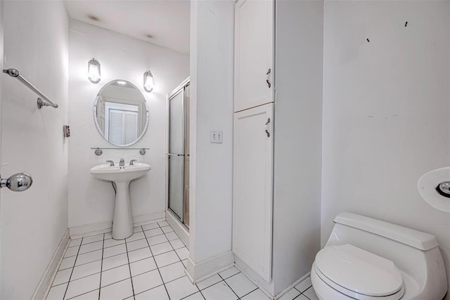 full bathroom with baseboards, toilet, a shower stall, and tile patterned flooring