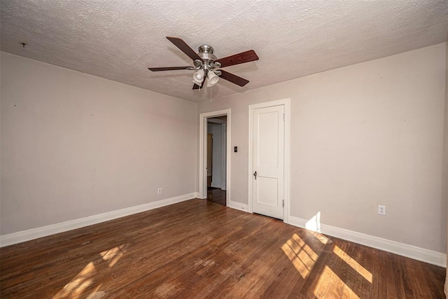 unfurnished bedroom featuring baseboards, a textured ceiling, wood finished floors, and a ceiling fan