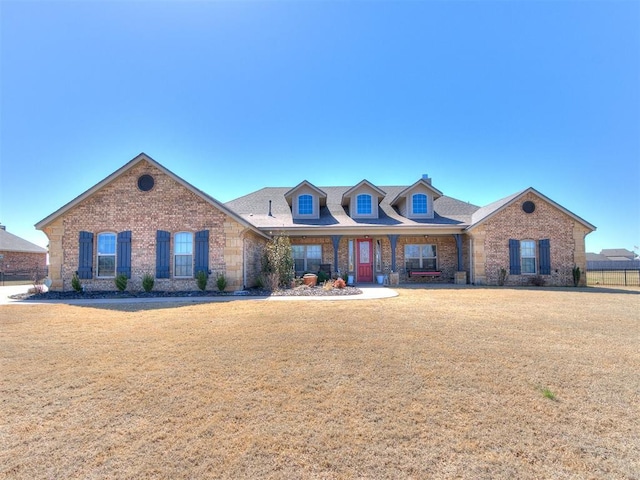 view of front facade featuring a front lawn and brick siding