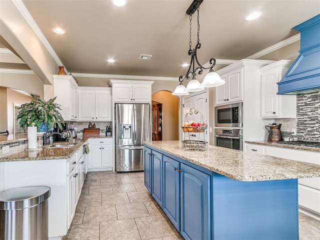 kitchen with a kitchen island, appliances with stainless steel finishes, arched walkways, white cabinets, and blue cabinets