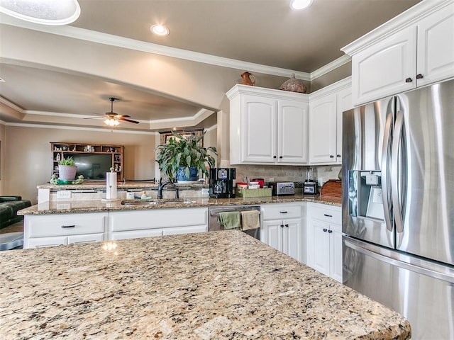 kitchen with ornamental molding, a ceiling fan, a sink, white cabinetry, and appliances with stainless steel finishes