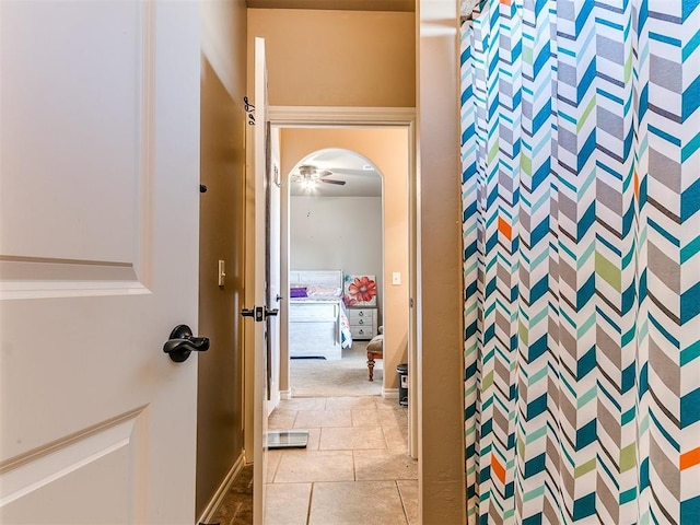 bathroom featuring curtained shower and tile patterned flooring