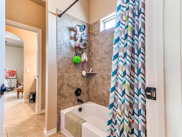 full bath featuring baseboards, shower / bath combo, and tile patterned flooring