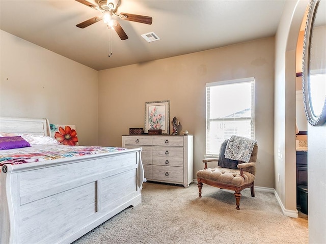 bedroom with visible vents, baseboards, light colored carpet, and ceiling fan