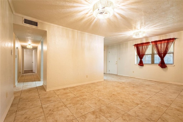 tiled empty room featuring a chandelier, visible vents, a textured ceiling, and crown molding