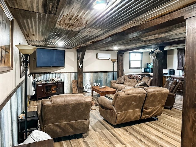 living area with wood finished floors, wood ceiling, a wainscoted wall, and a wall mounted air conditioner