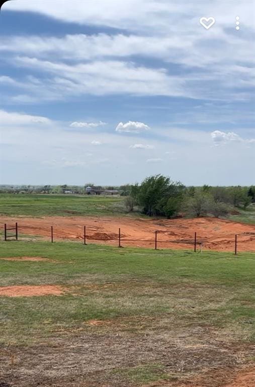 view of yard featuring a rural view and fence