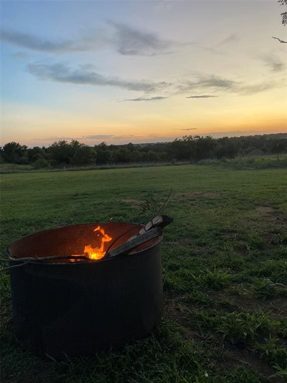 yard at dusk with a rural view