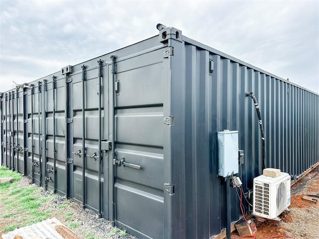 view of outdoor structure featuring ac unit and an outbuilding