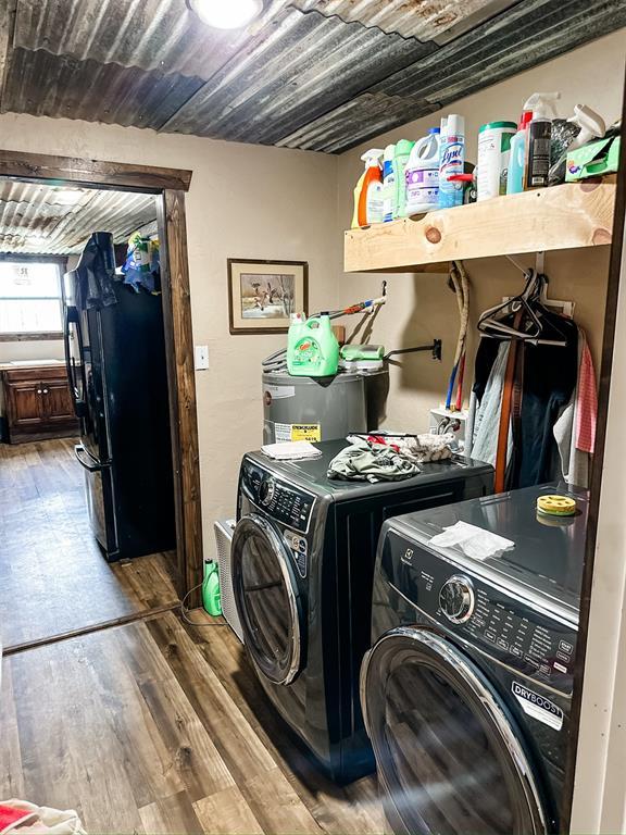 laundry area featuring laundry area, wood finished floors, separate washer and dryer, and wooden ceiling