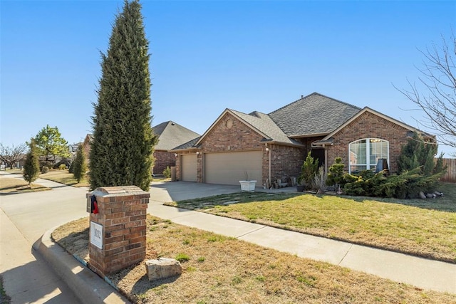 ranch-style house featuring driveway, roof with shingles, an attached garage, a front lawn, and brick siding