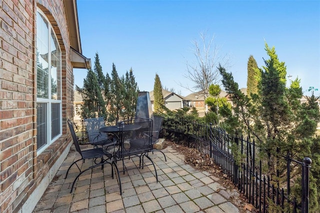 view of patio / terrace with outdoor dining area and fence