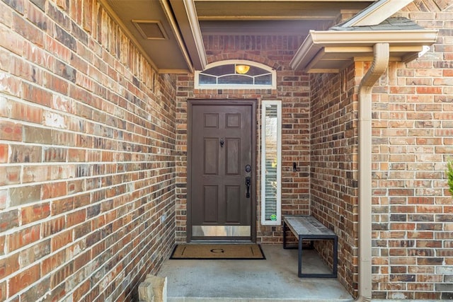 property entrance with brick siding