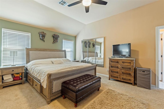 bedroom with visible vents, baseboards, lofted ceiling, light colored carpet, and ceiling fan