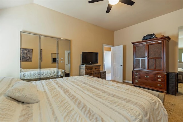 carpeted bedroom with ceiling fan and lofted ceiling