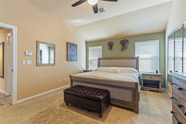 carpeted bedroom featuring visible vents, baseboards, ceiling fan, and vaulted ceiling