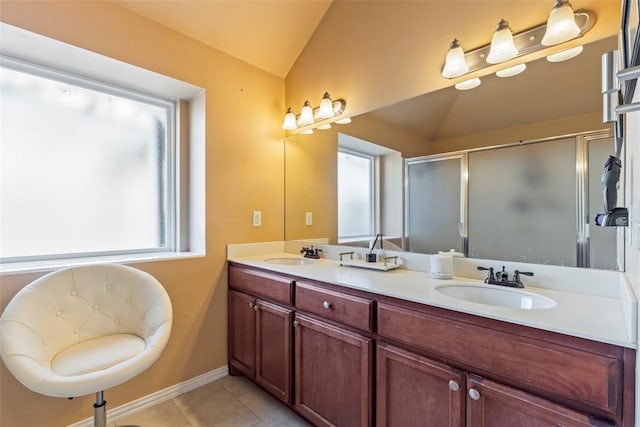 full bathroom featuring vaulted ceiling, a wealth of natural light, and a sink