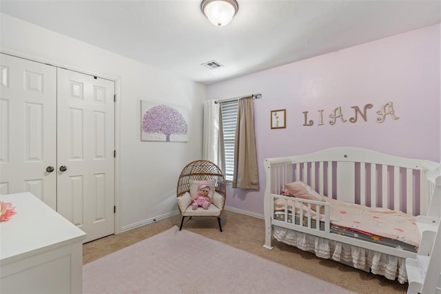 bedroom with visible vents, baseboards, light colored carpet, and a closet