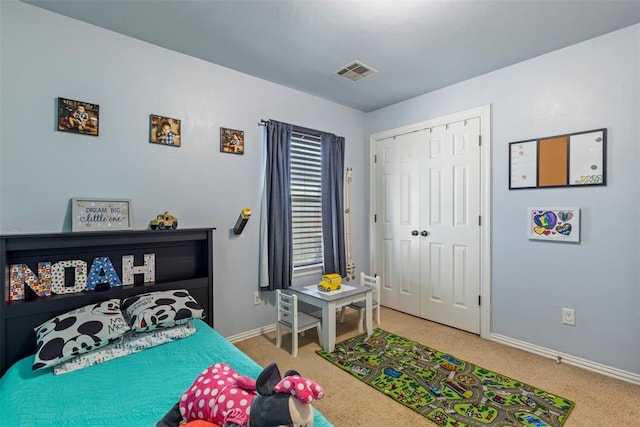 bedroom with a closet, baseboards, visible vents, and carpet floors