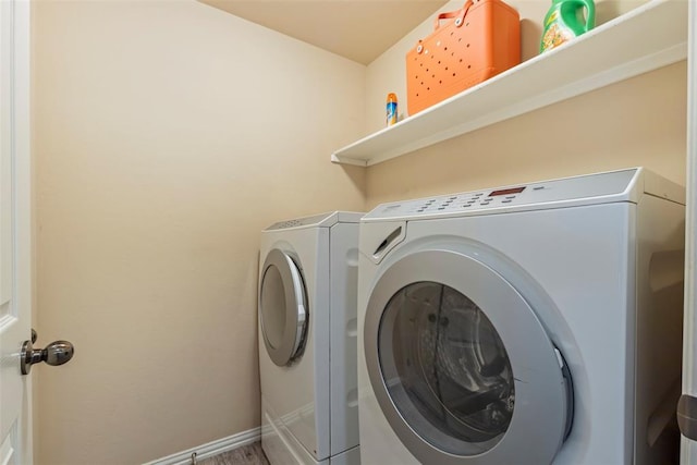 laundry room featuring washer and dryer, baseboards, and laundry area