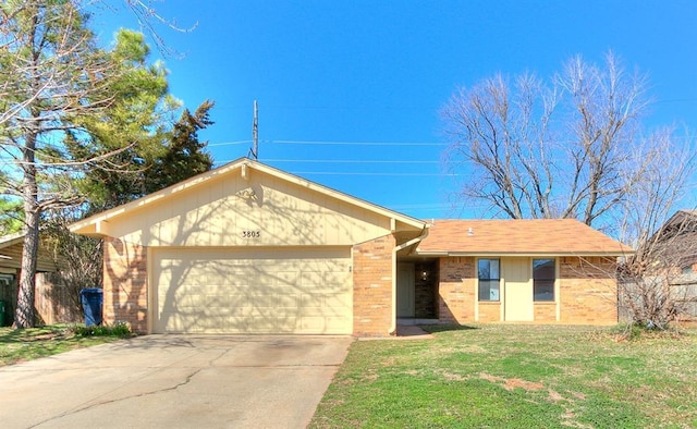 ranch-style home with brick siding, an attached garage, driveway, and a front lawn