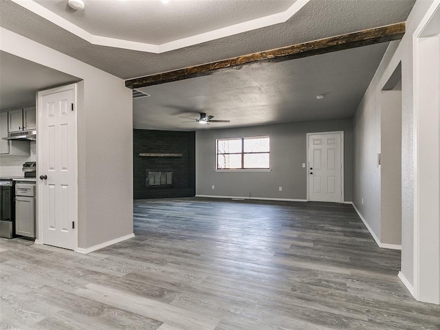 unfurnished living room with a ceiling fan, baseboards, light wood-style floors, and a fireplace