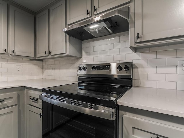 kitchen with range hood, gray cabinetry, and stainless steel electric range oven