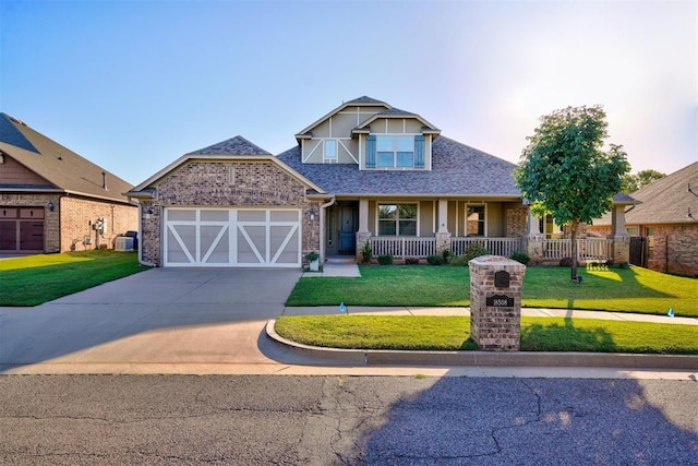 craftsman house with cooling unit, driveway, a porch, a front lawn, and a garage