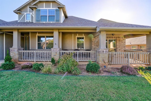 craftsman-style house with brick siding, covered porch, and a front lawn