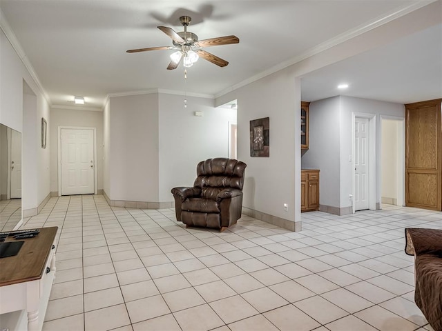 sitting room featuring light tile patterned flooring, baseboards, and ornamental molding