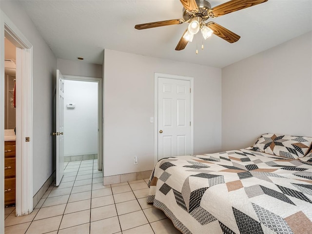 bedroom with light tile patterned flooring, baseboards, and a ceiling fan