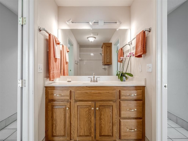 bathroom featuring tile patterned floors, vanity, and a shower with shower door