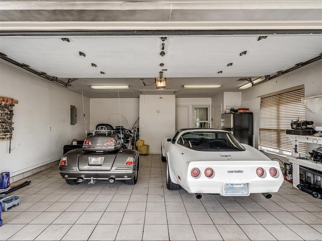 garage featuring refrigerator and electric panel